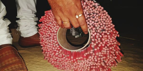Low section of man holding woman standing on floor