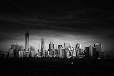 View of skyscrapers against cloudy sky