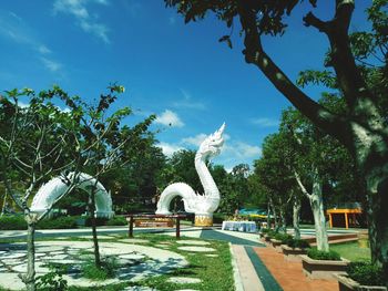 Statue in park against sky