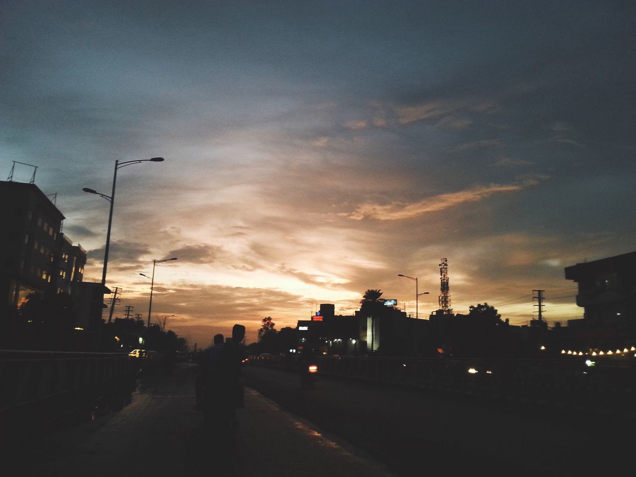 CITY STREET AGAINST SKY AT SUNSET