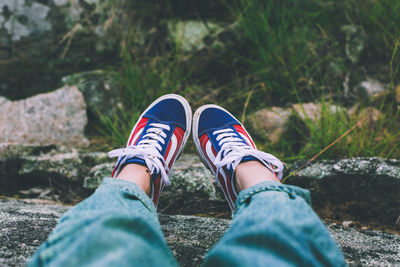 Low section of woman wearing canvas shoes