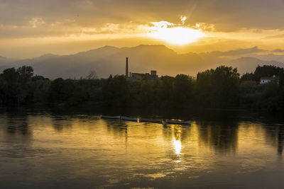 Scenic view of lake against sky during sunset