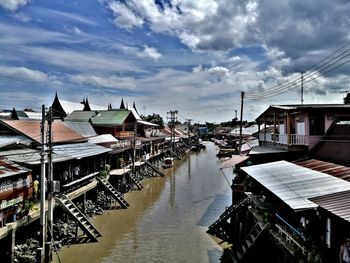 Boats moored at harbor against sky