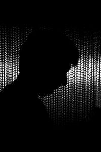 Close-up of silhouette man in dark room