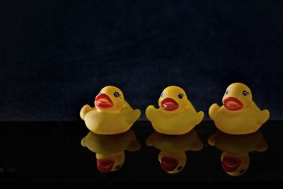 Rubber ducks against black background