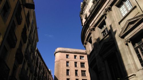 Low angle view of buildings against blue sky