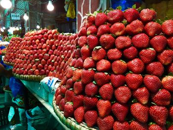 Strawberries arranged at market stall for sale
