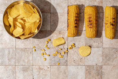 High angle view of yellow and coffee on tiled floor