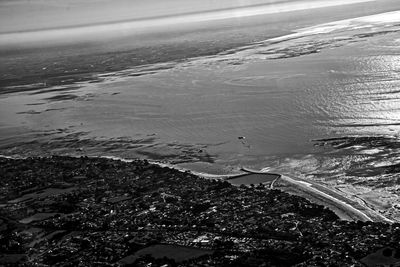 High angle view of airplane flying over sea