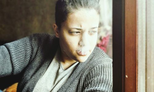 Close-up of young woman smoking