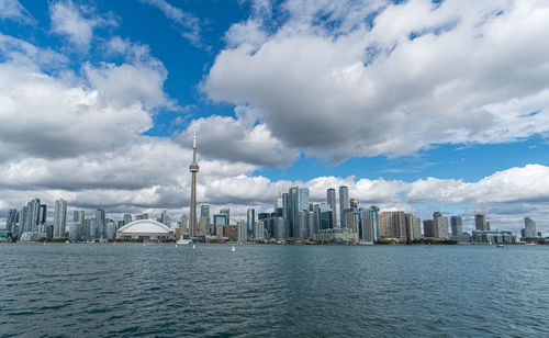 Panoramic view of sea and buildings against sky