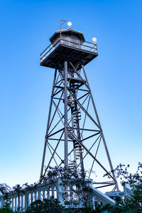 Low angle view of tower against clear blue sky