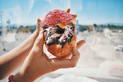 Close-up of hand holding a donut