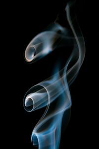 Close-up of smoke over black background 