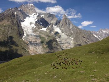 Scenic view of land and mountains against sky