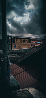 Information sign against sky in city