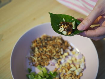 High angle view of hand holding bowl