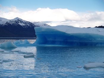 Scenic view of sea against mountain range