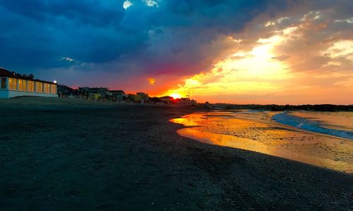 Scenic view of beach against sky during sunset