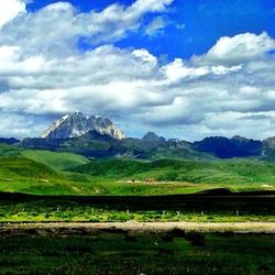 Scenic view of mountains against cloudy sky