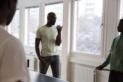 Coach gesturing while giving training to students in games room