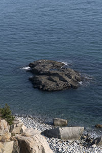 High angle view of rocks by sea