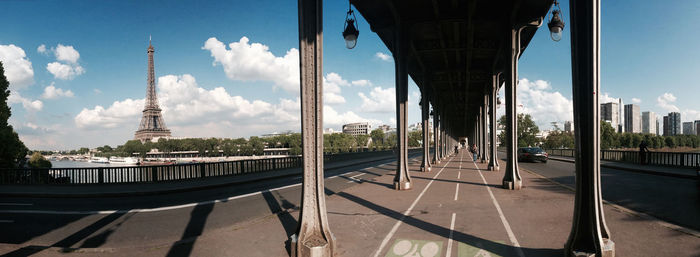 Panoramic shot of pont de bir-hakeim by eiffel tower against sky