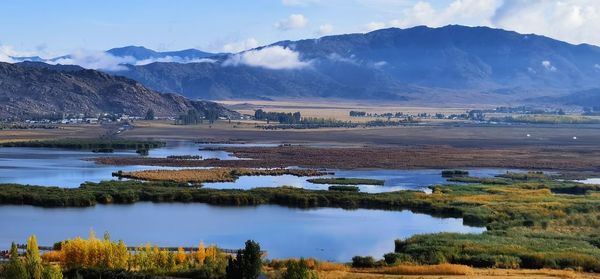 Scenic view of lake and mountains against sky