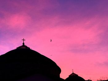 Low angle view of silhouette building against sky during sunset