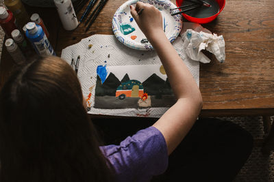 High angle view of woman sitting on table