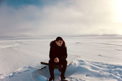 Full length of man on snow covered landscape
