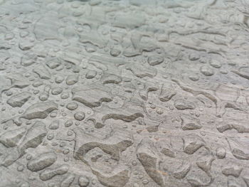 Full frame shot of raindrops on sand