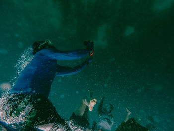 People swimming underwater in sea