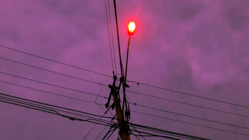 Low angle view of illuminated street light against sky