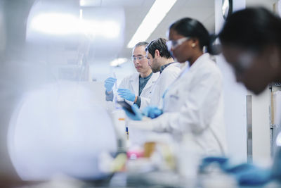 Doctors examining test tubes in laboratory