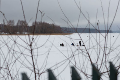 Scenic view of lake against sky during winter