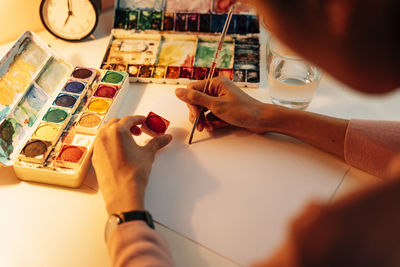 High angle view of woman hand on table