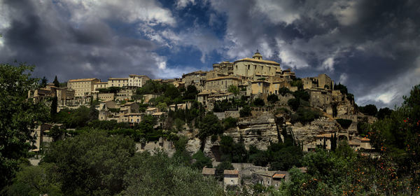 Buildings against cloudy sky