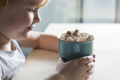 Close-up of girl holding hot chocolate