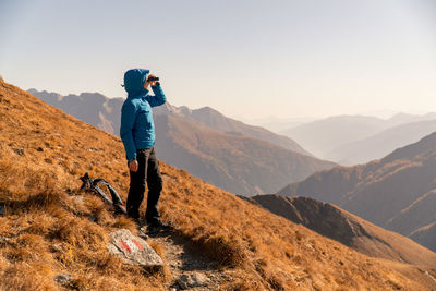 Full length of man standing on mountain against sky