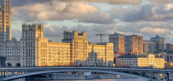 Buildings in city against cloudy sky