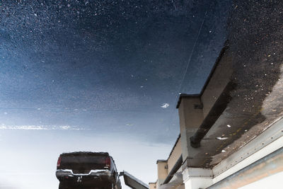 Cars on street against sky at night