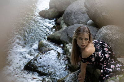 Portrait of young woman on rock