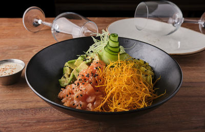 Poke bowl, traditional hawaiian raw salmon fish salad, with chopsticks and copy space. 