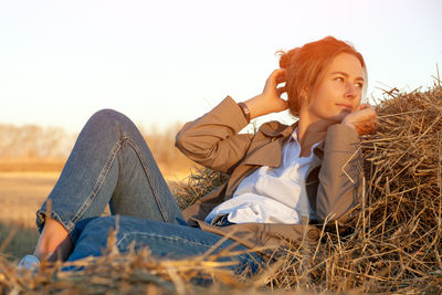 Portrait of a beautiful young model in in beige trench, white shirt 