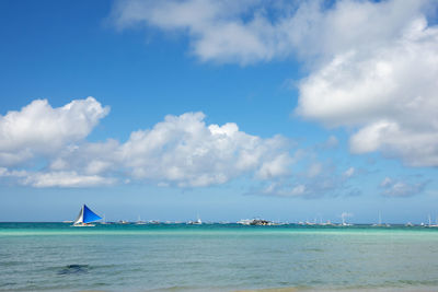 Sailboat in sea against sky