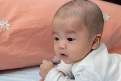 Portrait of cute baby on bed