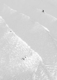 High angle view of people skiing on snowcapped mountain