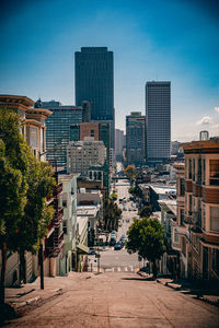 Street amidst buildings in city against sky