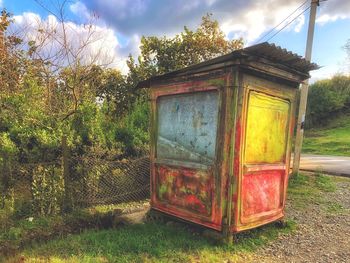 Rusty metallic structure on field against sky